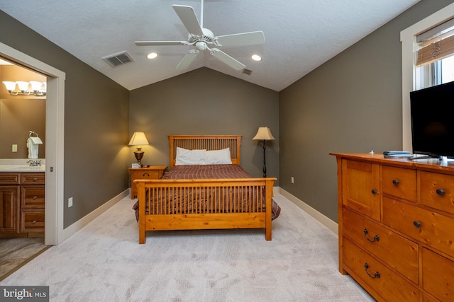 carpeted bedroom featuring vaulted ceiling, sink, ceiling fan, and ensuite bathroom