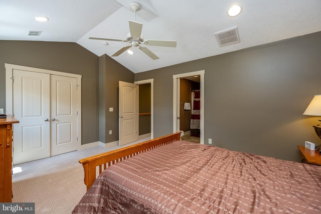 carpeted bedroom featuring a closet, vaulted ceiling, and ceiling fan