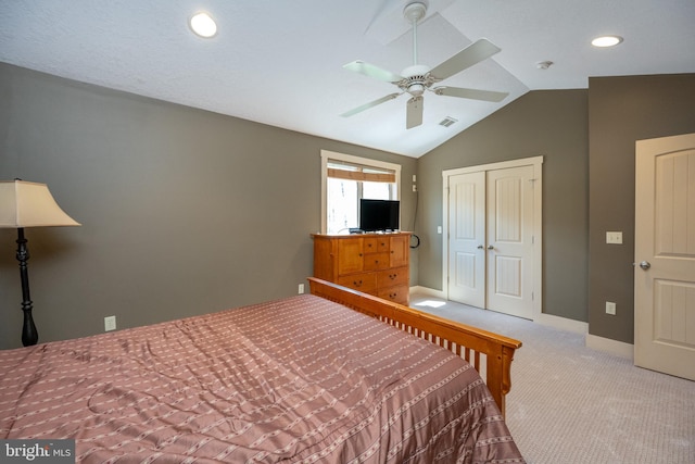 carpeted bedroom with lofted ceiling, ceiling fan, and a closet