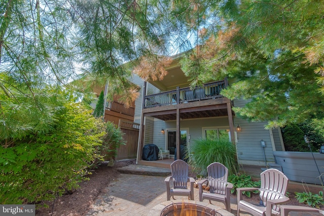 back of property featuring a balcony and a patio