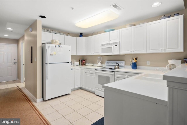 kitchen with white appliances, white cabinets, sink, and light tile patterned floors