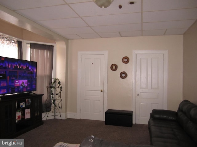 carpeted living room with a drop ceiling