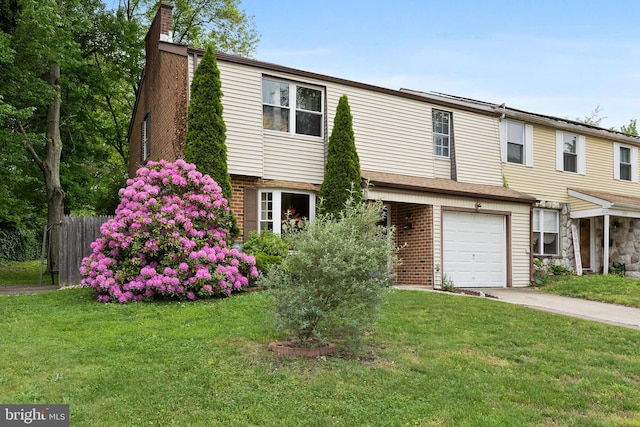 view of front of property with a garage and a front lawn