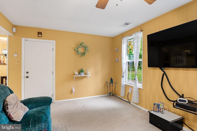 living area with a healthy amount of sunlight, carpet flooring, and ceiling fan