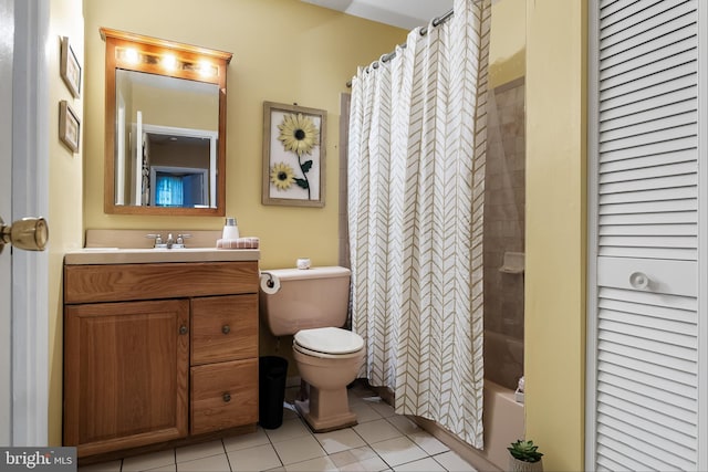 bathroom with tile flooring, vanity, and toilet