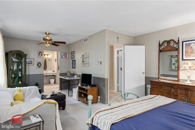 carpeted bedroom featuring ensuite bathroom and ceiling fan