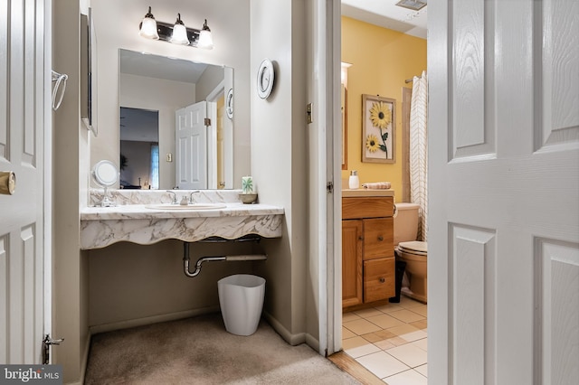 bathroom featuring tile floors, oversized vanity, and toilet