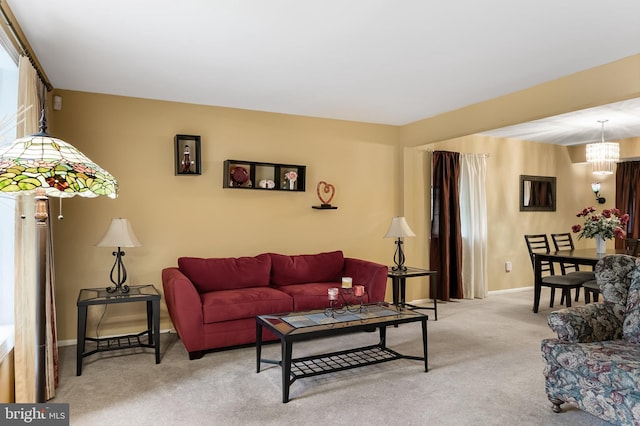 living room with a notable chandelier and carpet