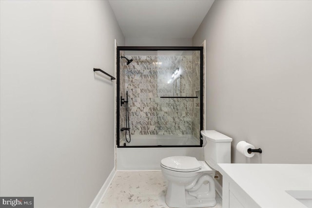 full bathroom featuring vanity, toilet, and combined bath / shower with glass door