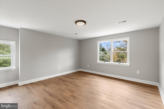 unfurnished room with light wood-type flooring