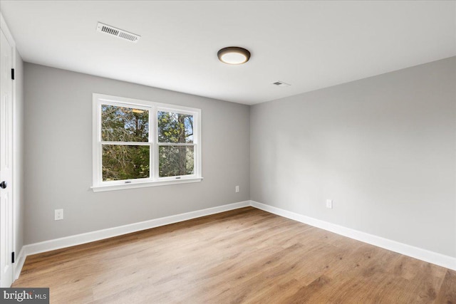 spare room featuring light wood-type flooring