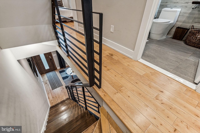 stairway featuring wood-type flooring