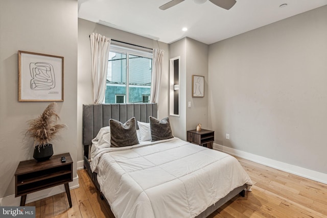 bedroom with ceiling fan and light wood-type flooring