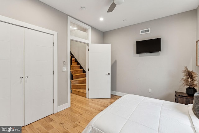 bedroom featuring a closet, light hardwood / wood-style flooring, and ceiling fan