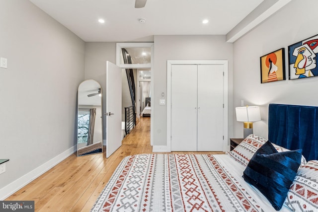 bedroom with ceiling fan, a closet, and light wood-type flooring