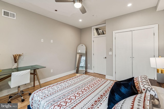 bedroom with a closet, ceiling fan, and hardwood / wood-style floors