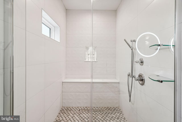 bathroom featuring a shower with shower door