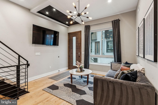 living room featuring an inviting chandelier and light hardwood / wood-style flooring