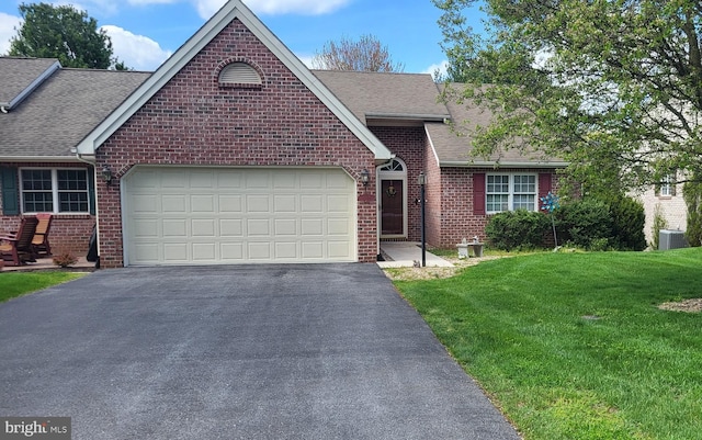 view of front of house featuring a garage, central AC, and a front lawn