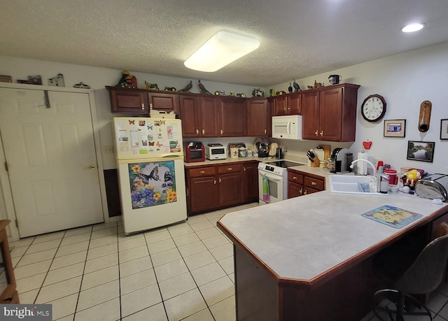 kitchen featuring kitchen peninsula, white appliances, a textured ceiling, sink, and light tile floors