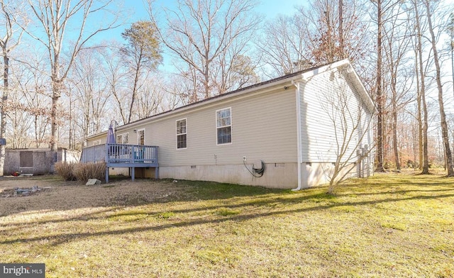 exterior space featuring a deck and a lawn