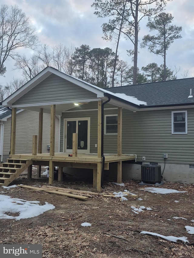 rear view of property with cooling unit and covered porch