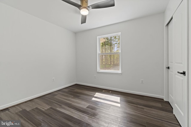 unfurnished bedroom with dark hardwood / wood-style flooring and ceiling fan