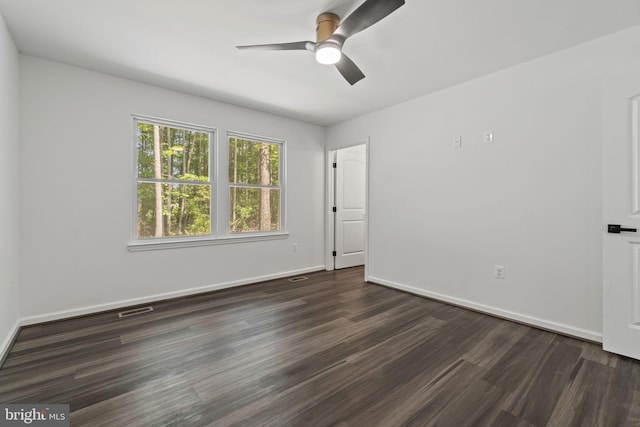 unfurnished room with ceiling fan and dark hardwood / wood-style flooring