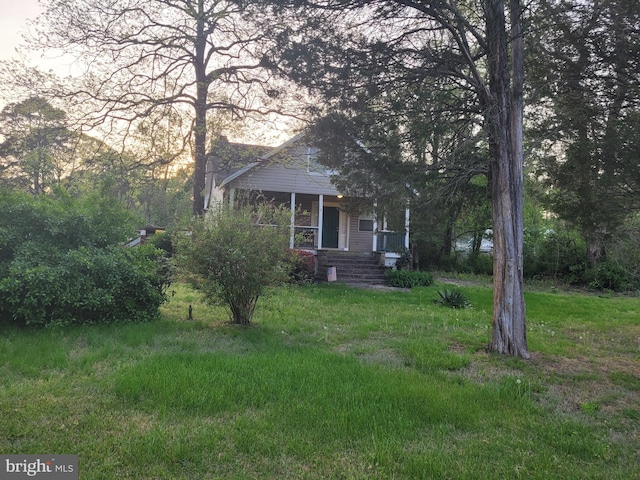 view of front of house with a yard and covered porch