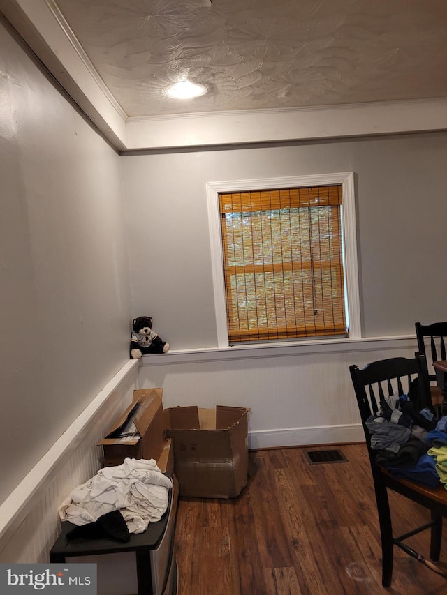 sitting room featuring crown molding and dark hardwood / wood-style flooring