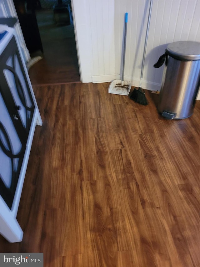 details featuring white range oven, wooden walls, and hardwood / wood-style floors