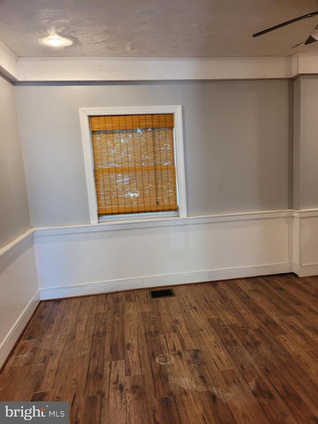 empty room featuring ceiling fan and dark hardwood / wood-style flooring