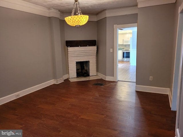 unfurnished living room with a textured ceiling, dark hardwood / wood-style floors, and a fireplace