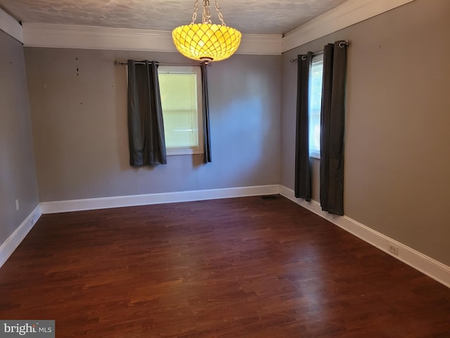 spare room featuring a textured ceiling and dark wood-type flooring