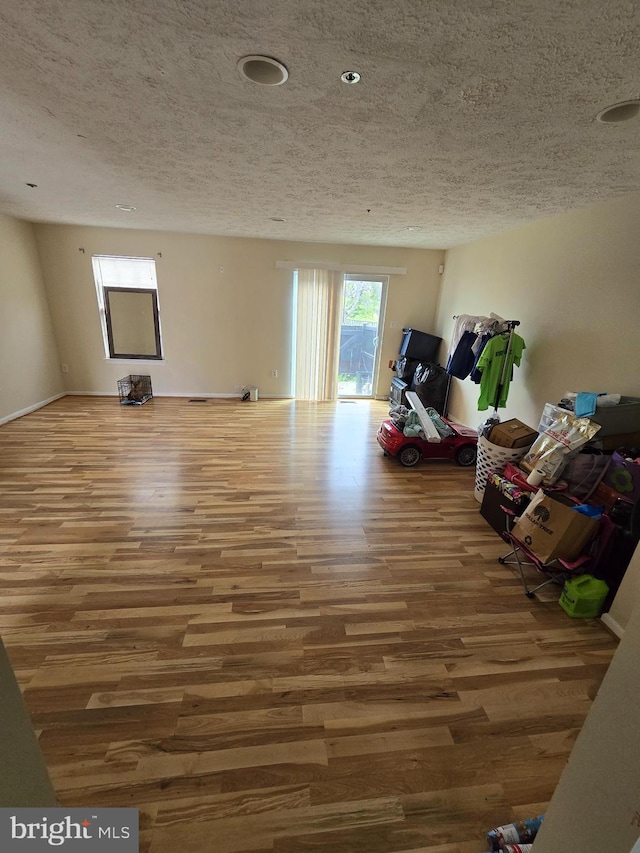 interior space featuring a textured ceiling and hardwood / wood-style flooring