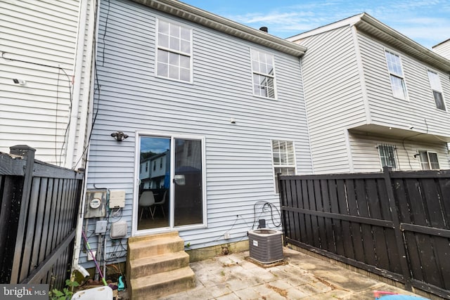 back of house with a patio area and central AC