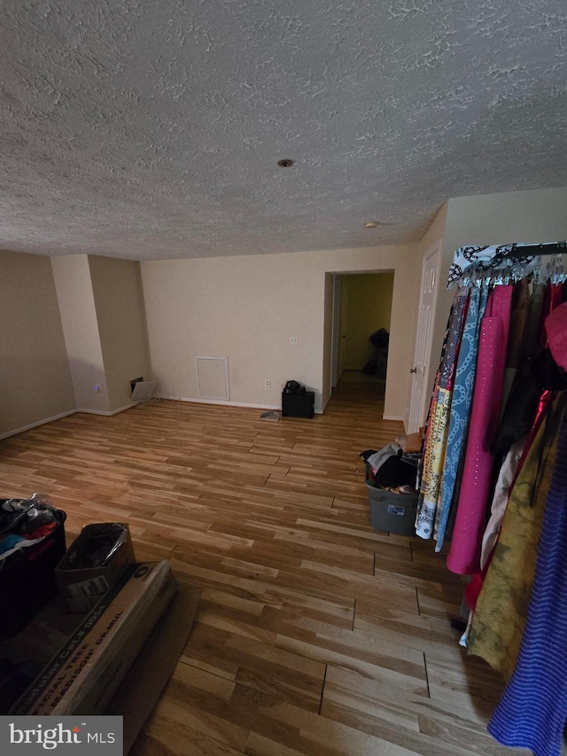 interior space with wood-type flooring and a textured ceiling