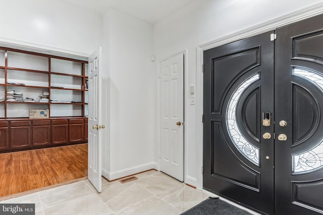 entrance foyer with french doors and light tile floors