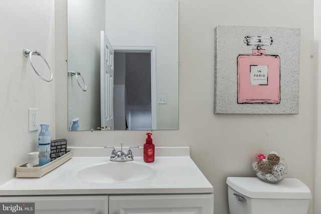 bathroom with large vanity and toilet