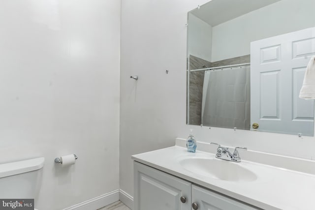 bathroom featuring vanity with extensive cabinet space and toilet