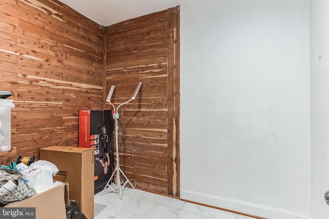 bathroom featuring wood walls and tile floors