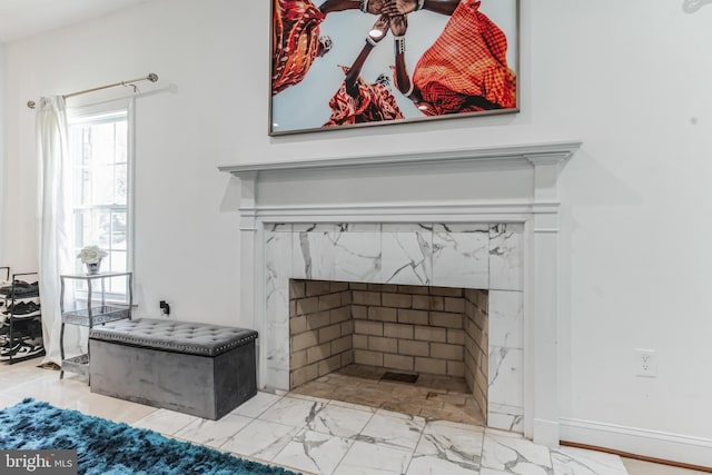 details featuring a premium fireplace and light tile flooring