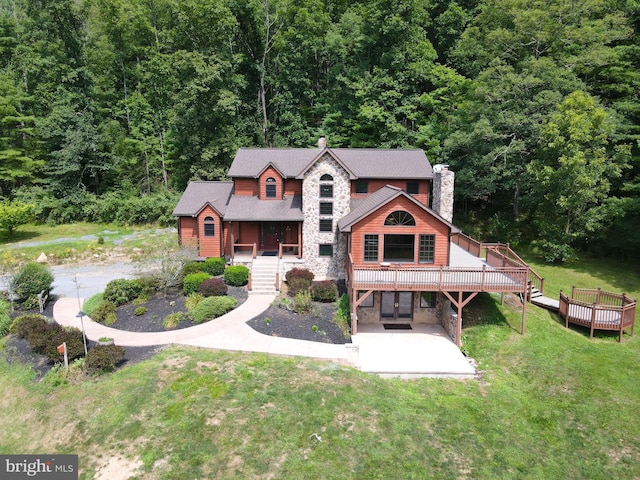 view of front of property with a deck and a front yard