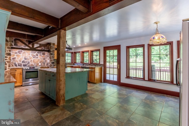 kitchen with decorative light fixtures, appliances with stainless steel finishes, beamed ceiling, and a kitchen island