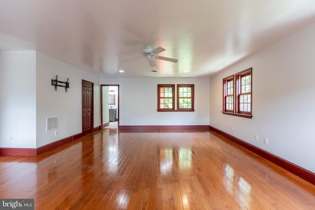 empty room with ceiling fan and wood-type flooring