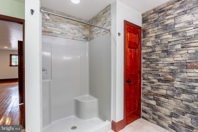 bathroom with tile patterned floors and walk in shower