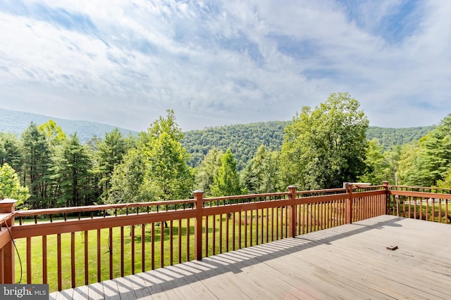 wooden deck with a lawn