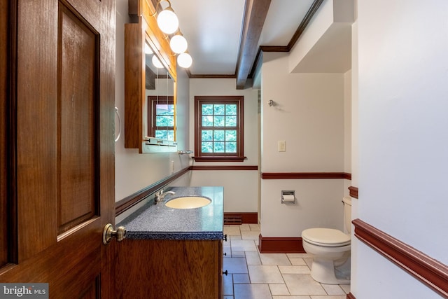 bathroom featuring toilet, vanity, tile patterned flooring, and beam ceiling