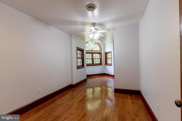 empty room featuring ceiling fan and hardwood / wood-style floors