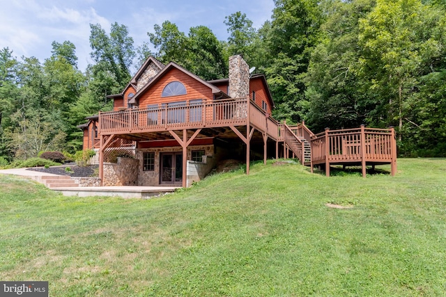 back of house with a yard and a wooden deck